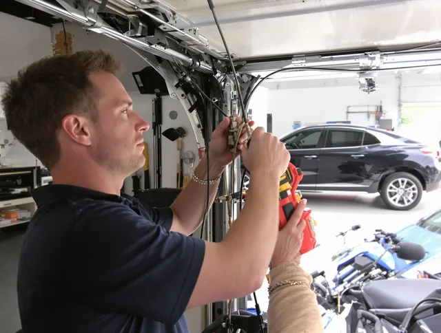 Akron Garage Door Repair safety certified technician performing cable replacement in Akron