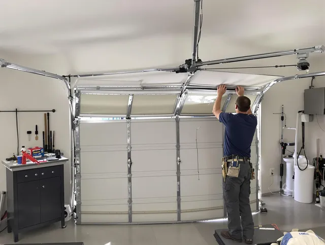 Akron Garage Door Repair specialist performing precise section replacement on Akron garage door